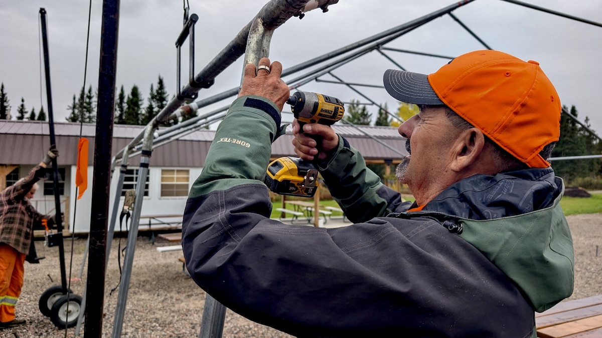 Armed with power tools and determination, Local Services Board of Melgund Chair Pat Daignault unfastens metal framing while dismantling the event tents at the Dyment Recreation Hall and Park.